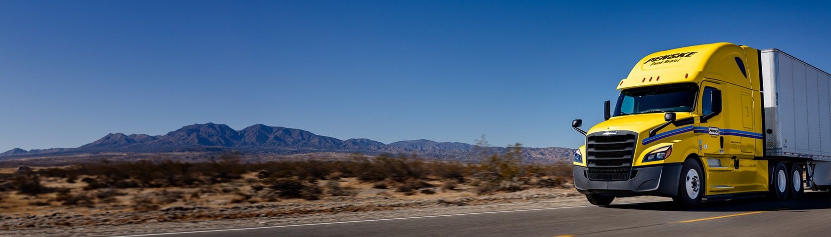 Penske tractor trailer driving in the desert